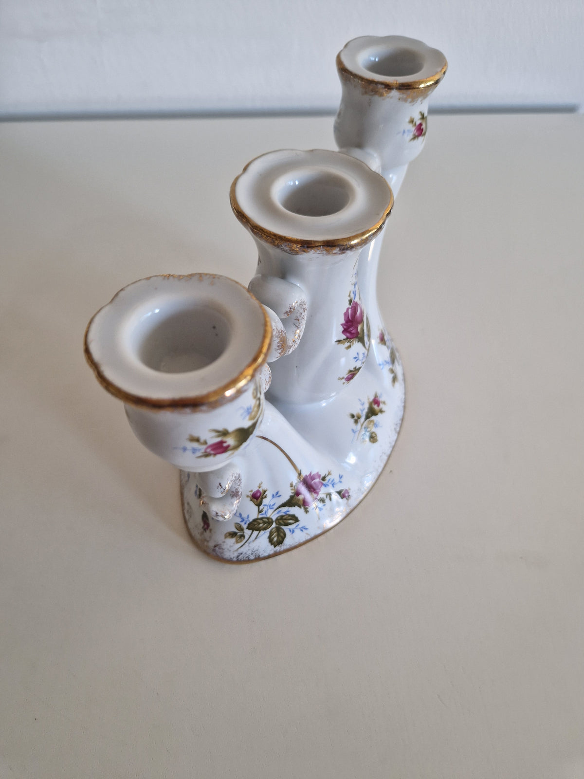Vintage white porcelain triple candle holder with gold trim and floral rose patterns