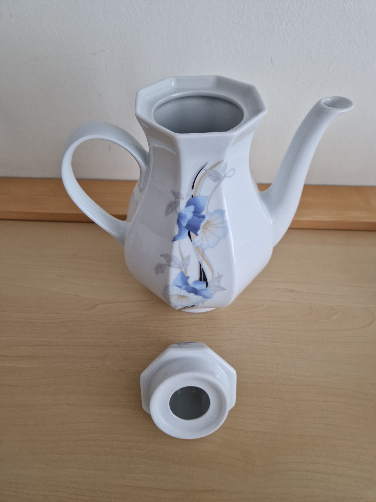 Vintage white porcelain coffee pot with blue floral pattern and matching lid