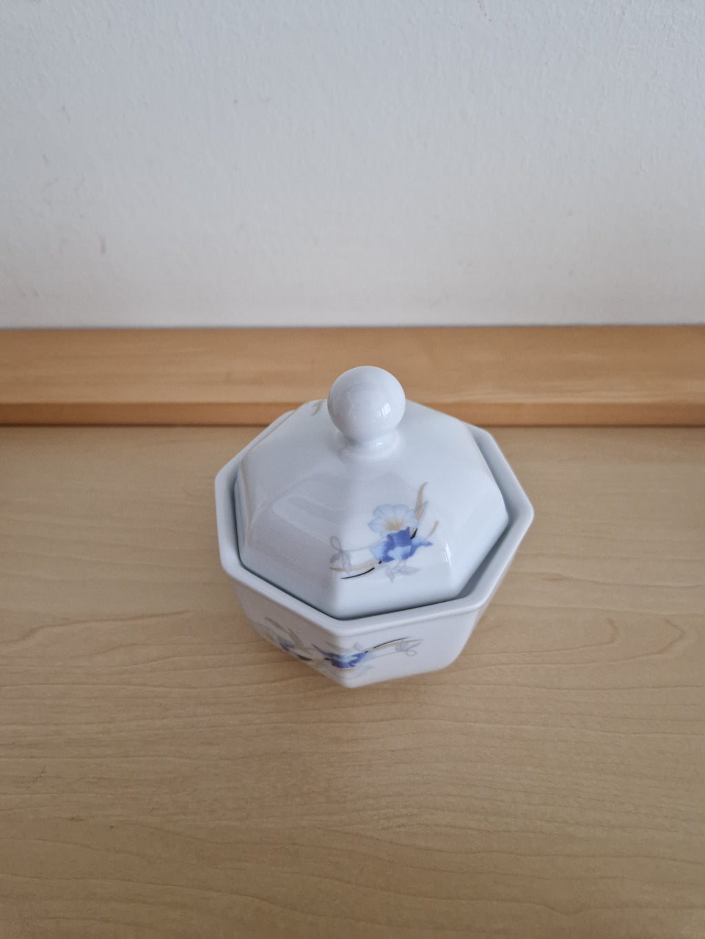 Vintage white porcelain sugar bowl with lid and blue floral pattern