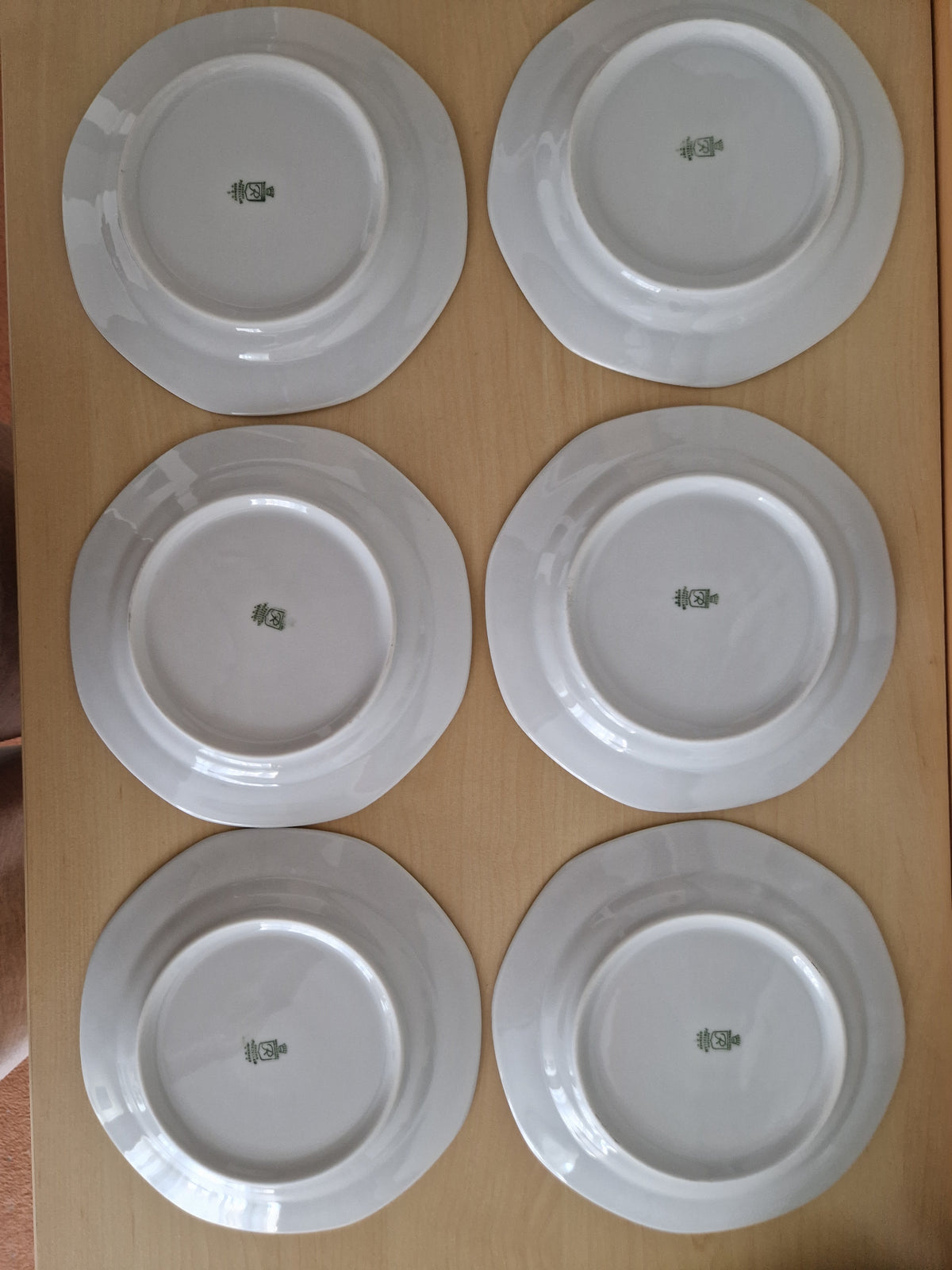 Set of six vintage white porcelain plates with maker's marks on the underside