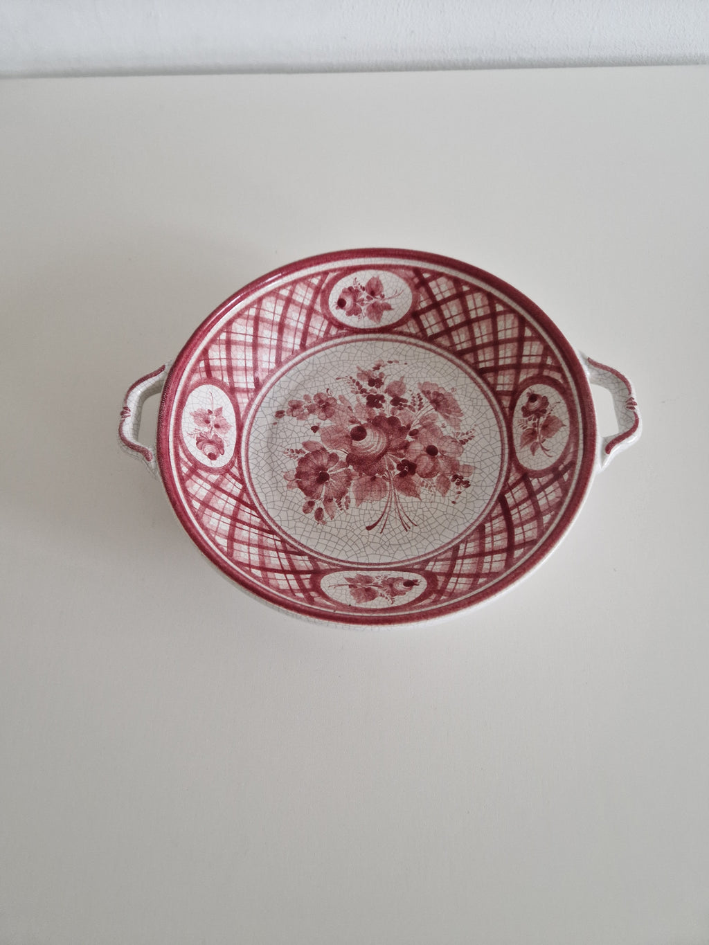 Gmundner Keramik hand-painted serving bowl front view showing pink floral lattice pattern and double handles