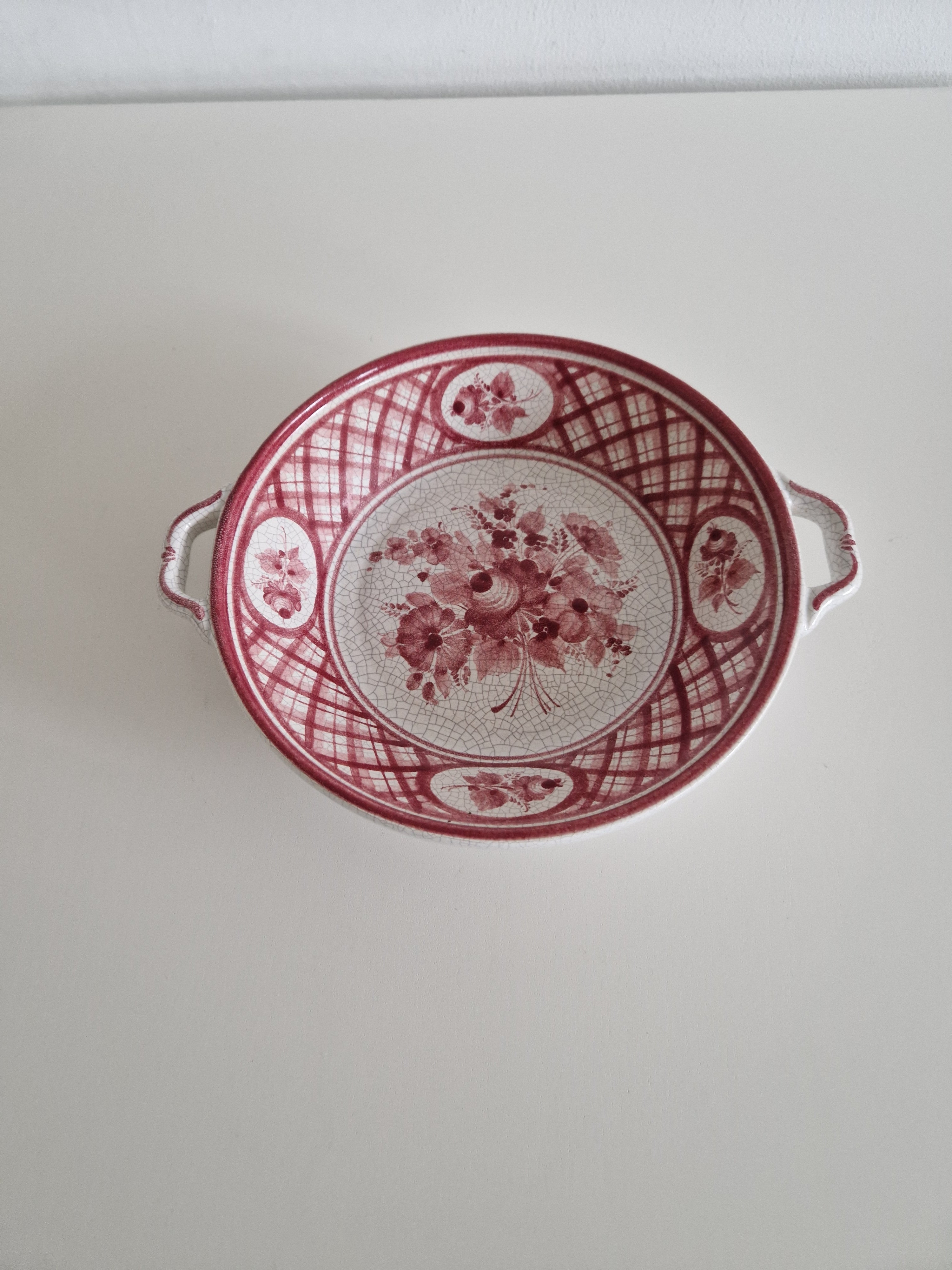 Gmundner Keramik hand-painted serving bowl front view showing pink floral lattice pattern and double handles
