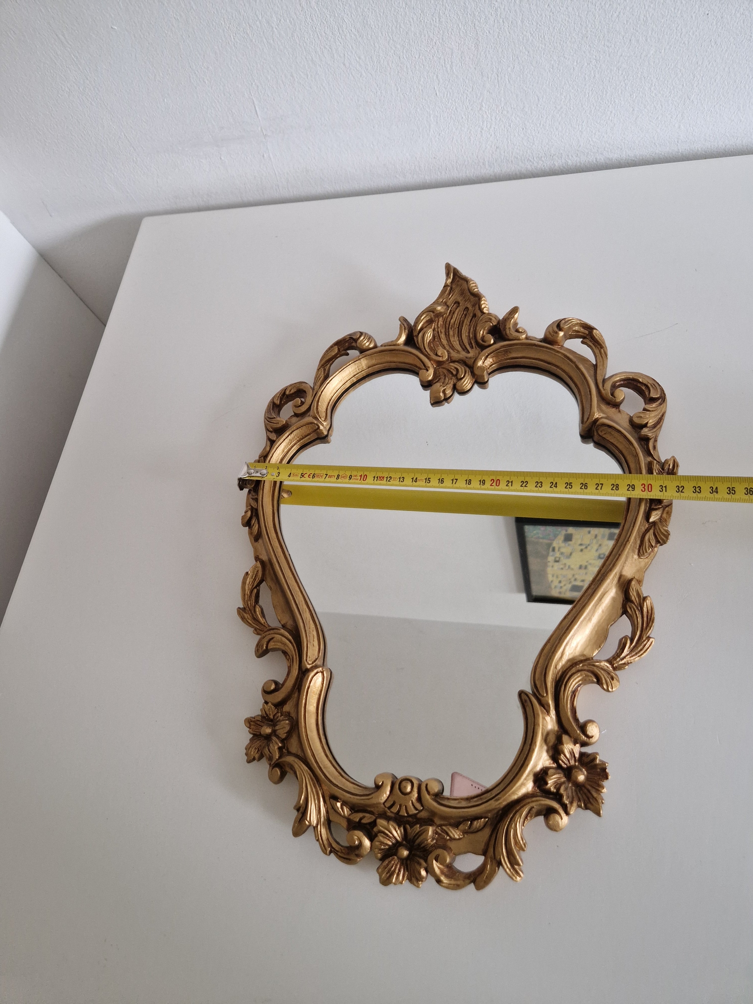 Side view of vintage Rococo gilt mirror showing frame depth and width measurement