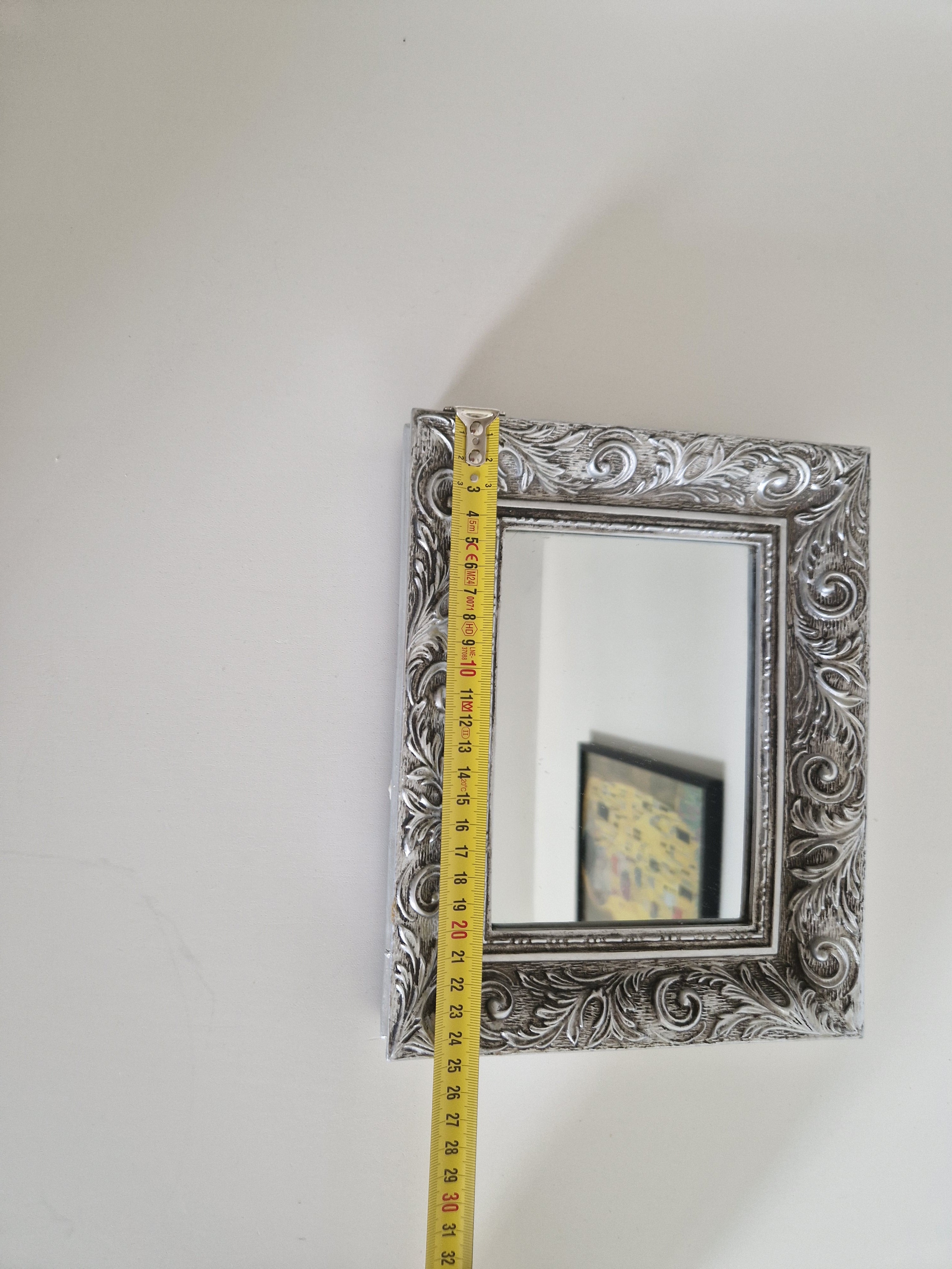Baroque ornate silver wall mirror with tape measure showing 32cm height, full frame detail