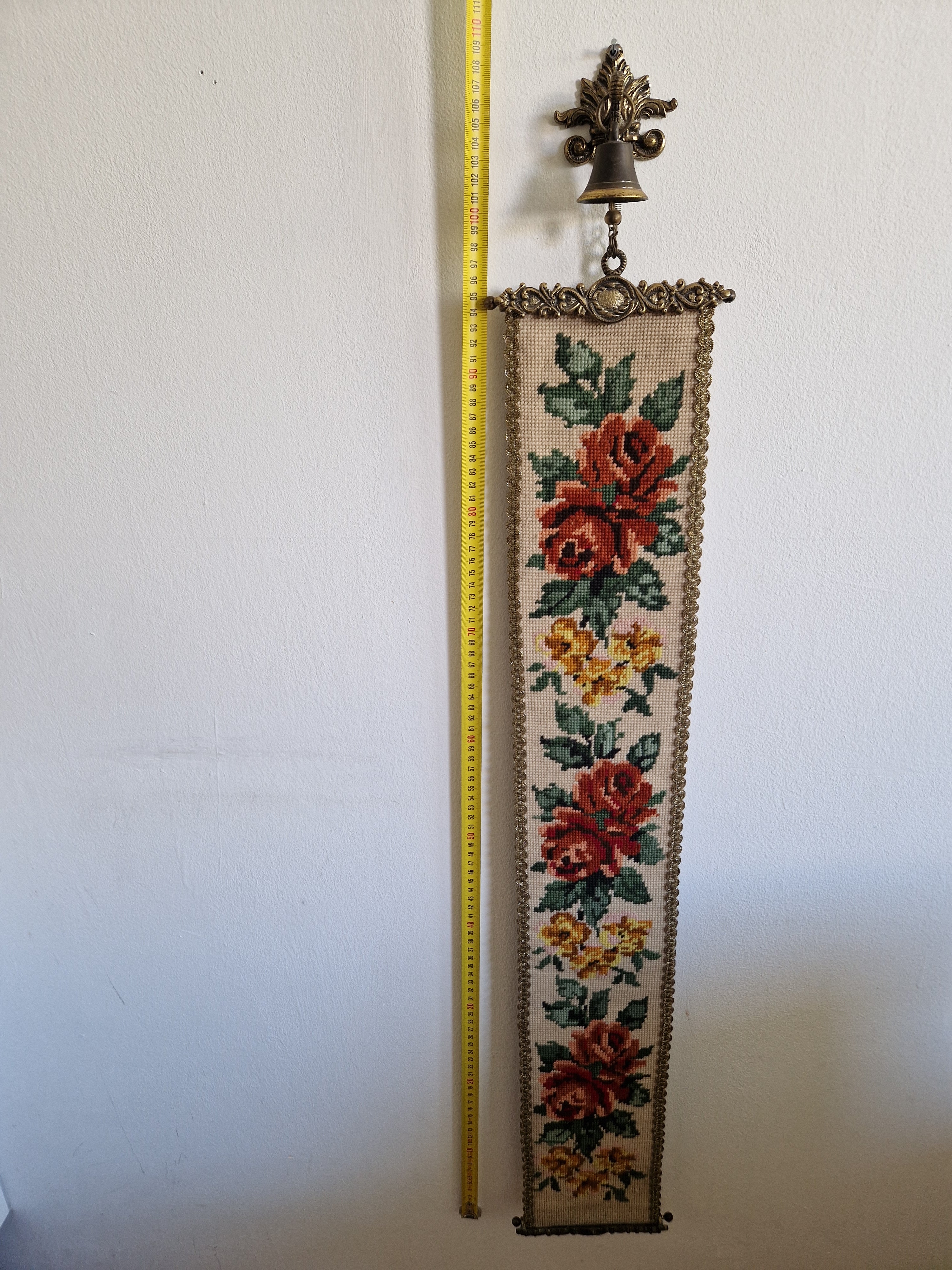 Antique needlepoint bell pull full length view with tape measure showing approx 100cm height, floral rose tapestry with brass mounts and bell