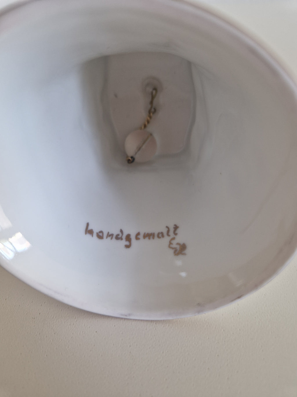 Base of porcelain bell showing handgemalt inscription confirming hand-painted provenance