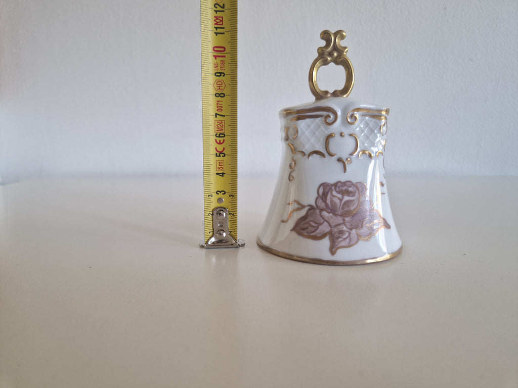 Porcelain bell with tape measure showing approx 9cm height