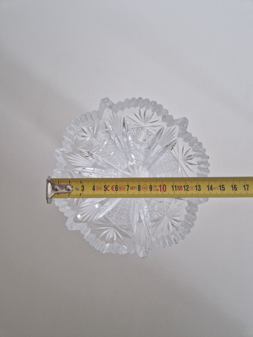 Vintage cut crystal vase — close-up of sawtooth rim, fan cuts and star motifs