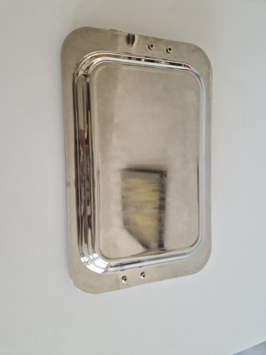 Underside of tray showing four bolt fixings securing the handles