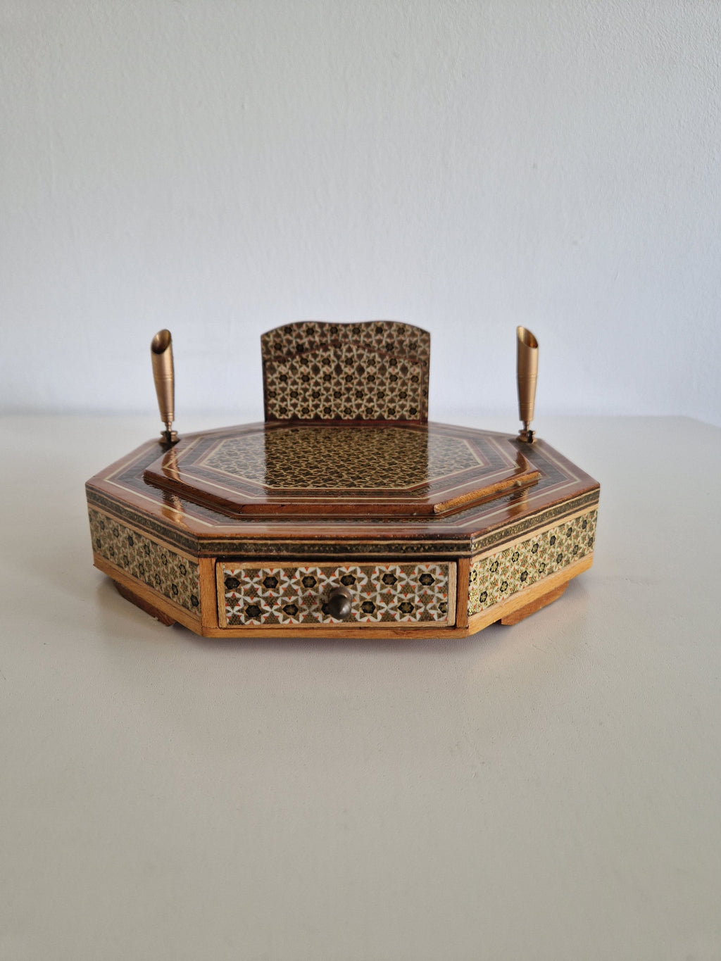 Close-up of Khatam kari micro-mosaic geometric star inlay on top surface