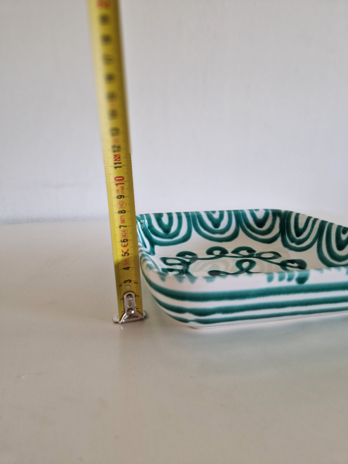 Side view of Gmundner Keramik dish showing horizontal green stripe exterior decoration