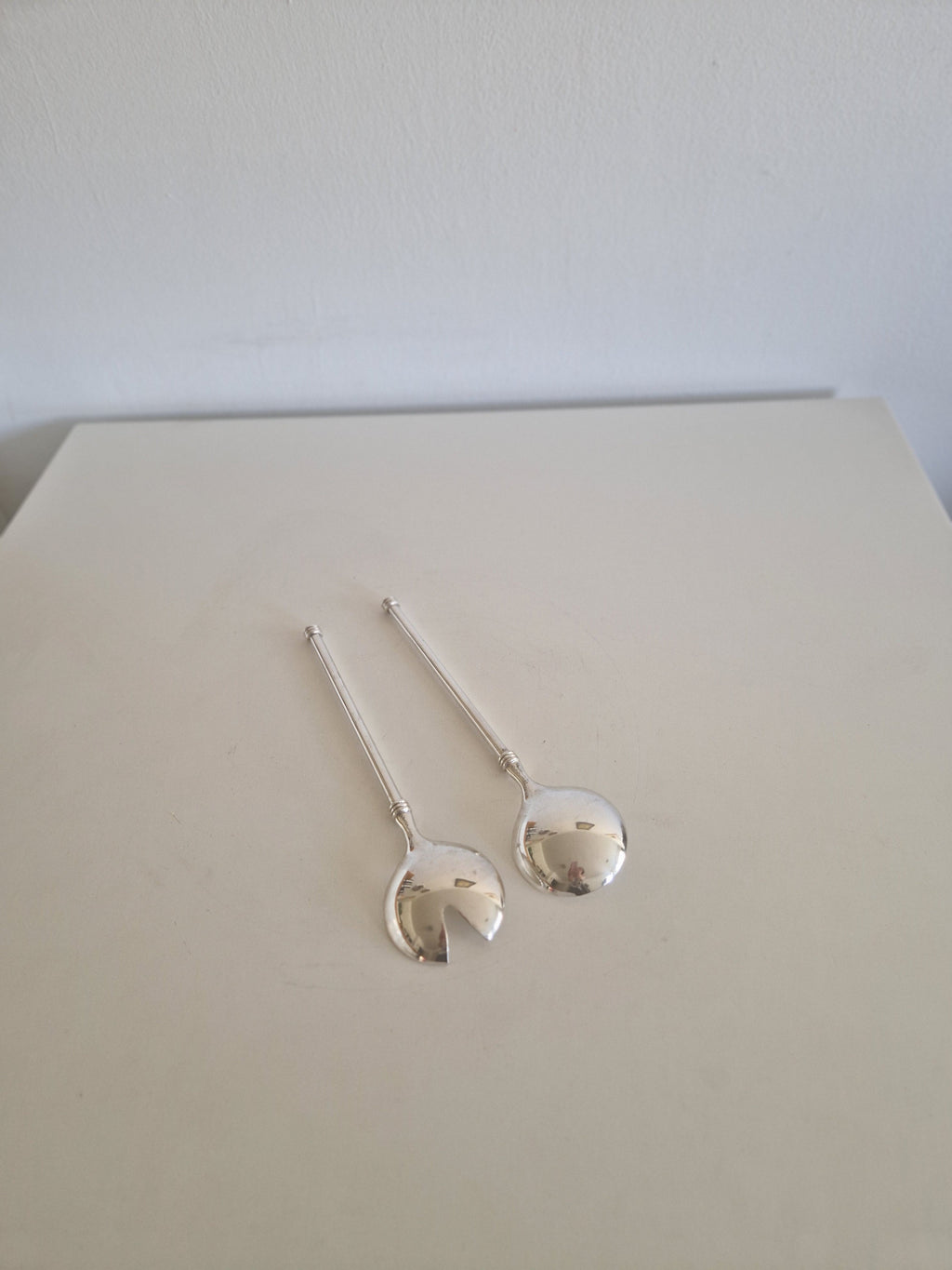 Close-up of ball finial and collar ring detail on WMF vintage silver-plated salad server handle