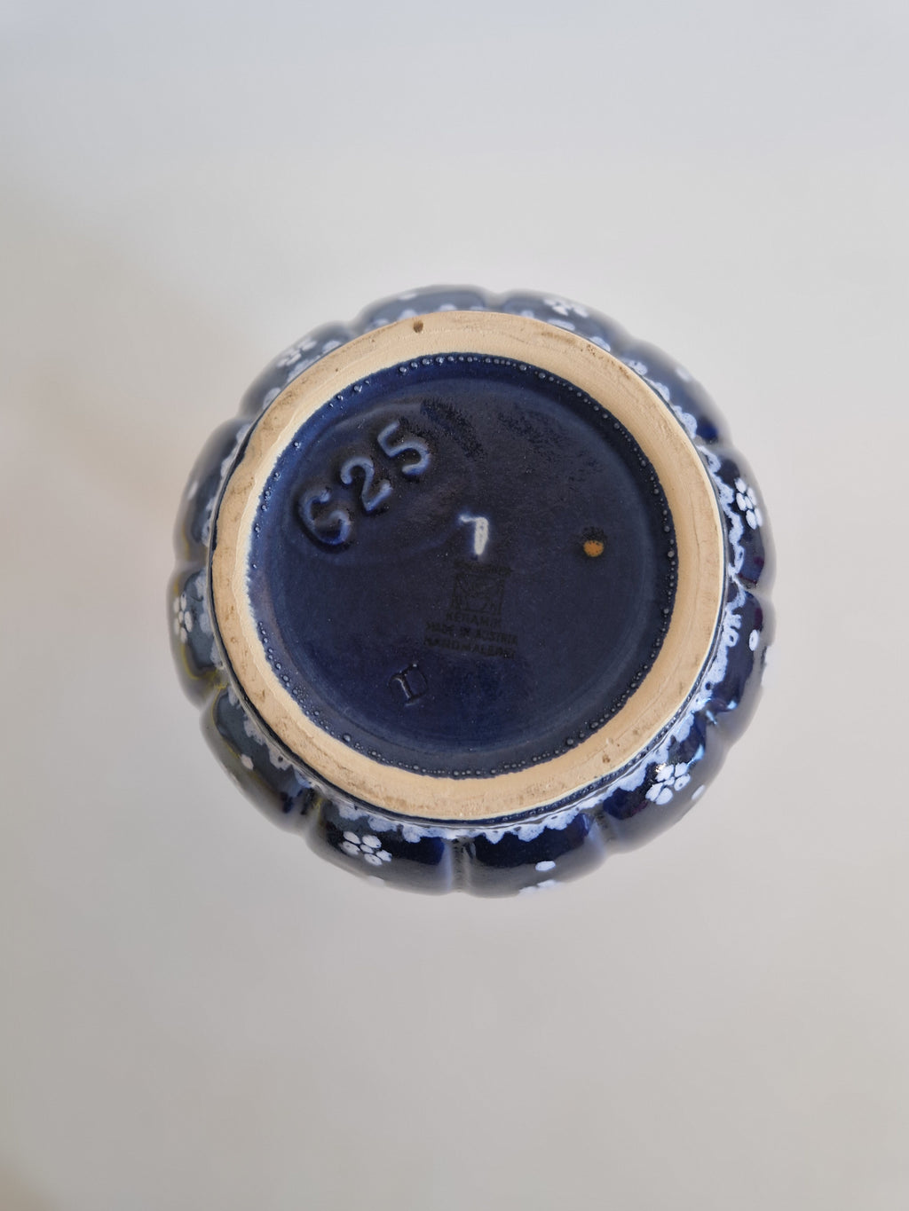 Underside of a vintage blue floral porcelain vase showing maker's mark and number 625.