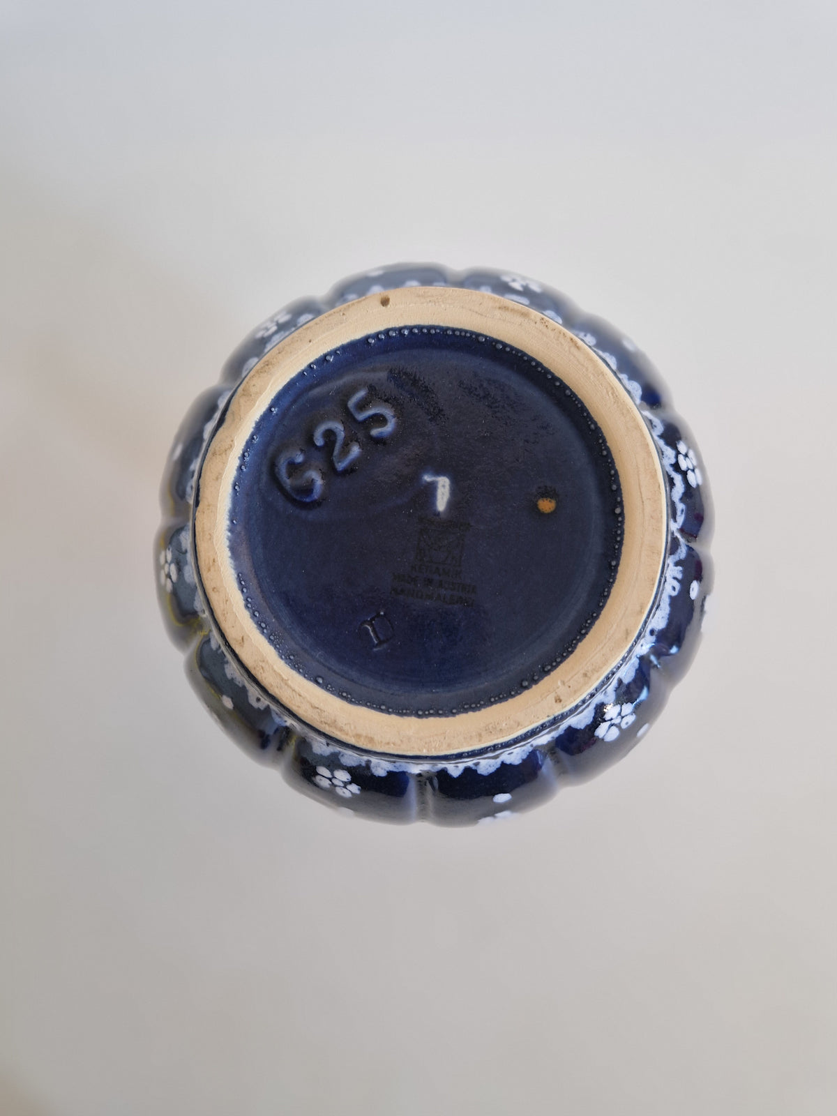 Underside of a vintage blue floral porcelain vase showing maker's mark and number 625.