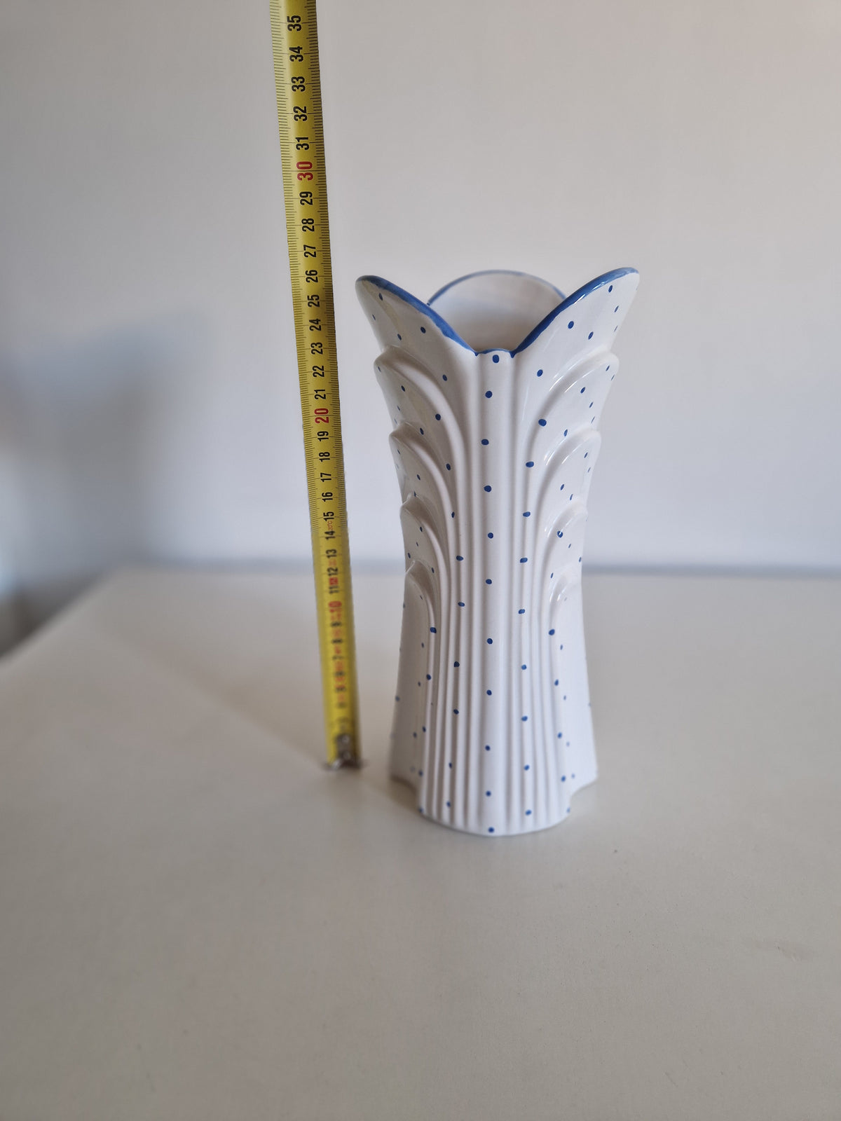 White porcelain vase with blue polka dots and fluted design, 30cm tall.