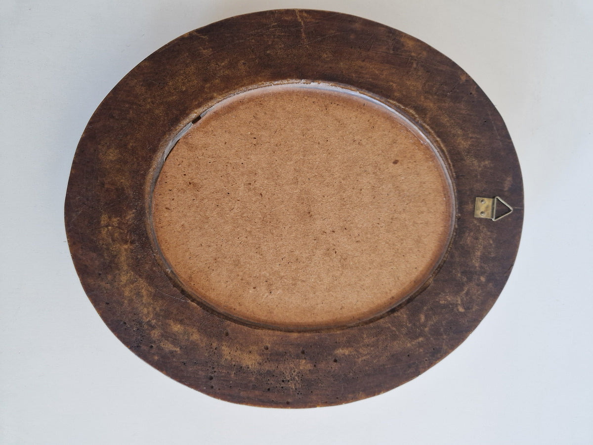 Reverse side of carved wood oval mirror showing hanging hook
