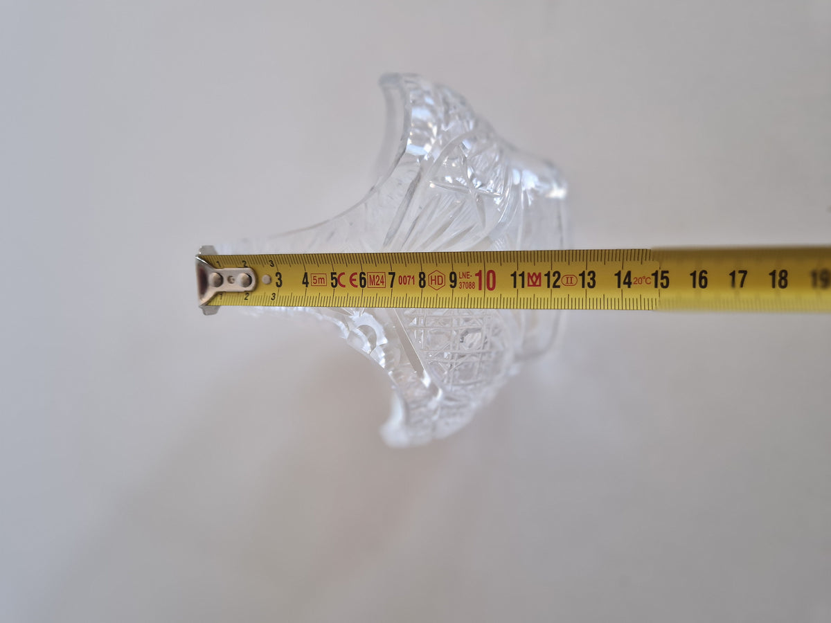 Vintage cut glass vase with a yellow measuring tape showing its size