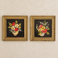 Pair of framed floral still life pictures with distressed gold-tone frames on an ivory wall
