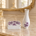 Hollóháza white porcelain vase and lidded box with purple flowers on an elegant ivory vanity