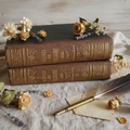 Voltaire books on cream linen with quill and flowers